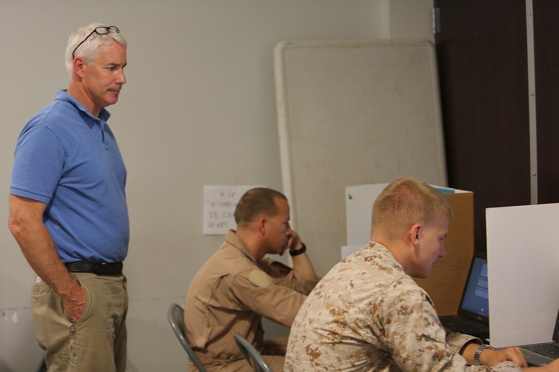 Alex Fisak, a civilian contractor and Automated Neuropsychological Assessment Metrics supervisor, observes a Marine with 7th Engineer Support Battalion, 1st Marine Logistics Group, take the test as part of the unit's pre-deployment training aboard Camp Pendleton, Calif., Sept. 4, 2013. The test consists of 50 questions taken over a 20 minute period and assesses different brain functions to ensure Marines are ready for deployment. 
