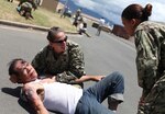 Navy personnel react to a humanitarian assistance and disaster relief scenario during the Rim of the Pacific 2012 exercise at Joint Base Pearl Harbor, Hawaii, June 20, 2012. Twenty-two nations, more than 40 ships and submarines, more than 200 aircraft and 25,000 personnel participated in the biennial exercise.