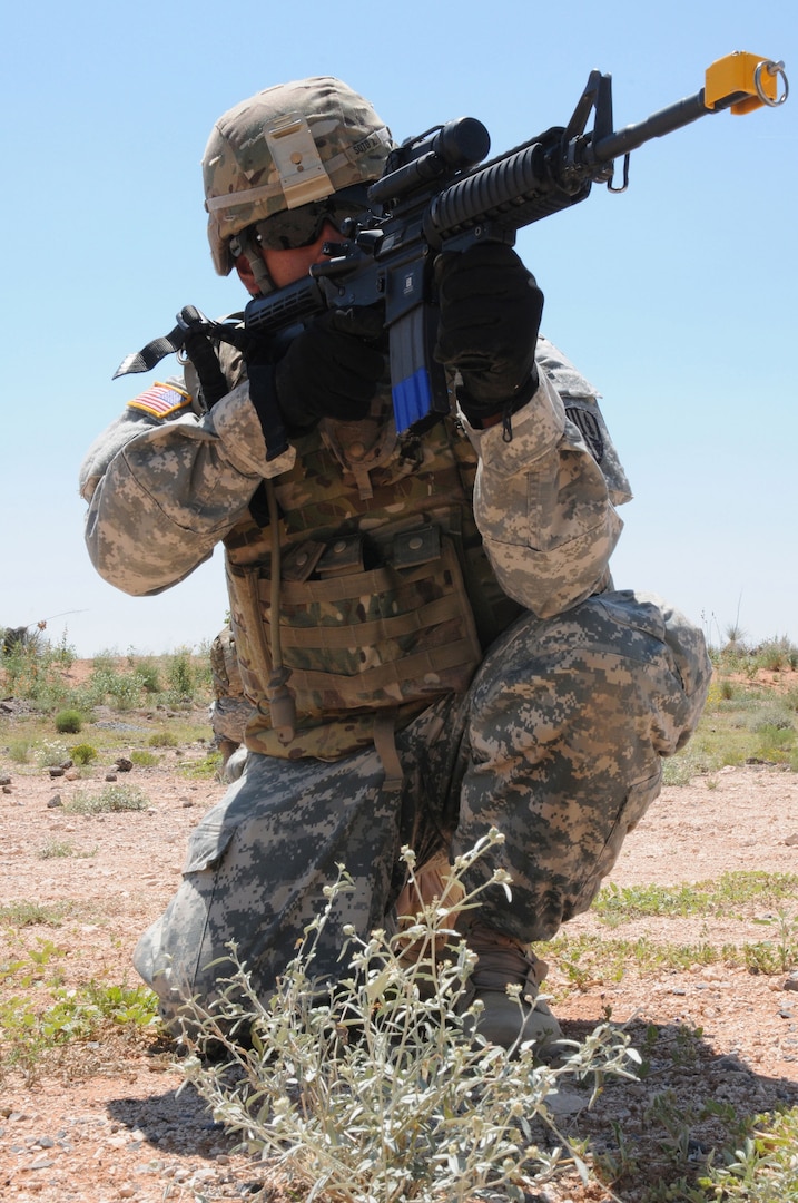 A soldier from the 101st Expeditionary Signal Battalion pulls security in a 360-degree formation with other soldiers from the unit, after the sighting of an improvised explosive device, during a counter-IED training exercise at Camp McGregor, N.M., Thursday afternoon. Soldiers from the 101st are currently going through pre-mobilization training at Camp McGregor prior to a deployment to Afghanistan.