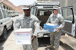 Army Sgt. Timothy Ryan, part of the Texas Army National Guard's 3rd Squadron, 124th Cavalry Regiment, and Sgt. 1st Class Loren Ledlow of the same unit, deliver several boxes of personal hygiene items to an orphanage in Dire Dawa, Ethiopia.