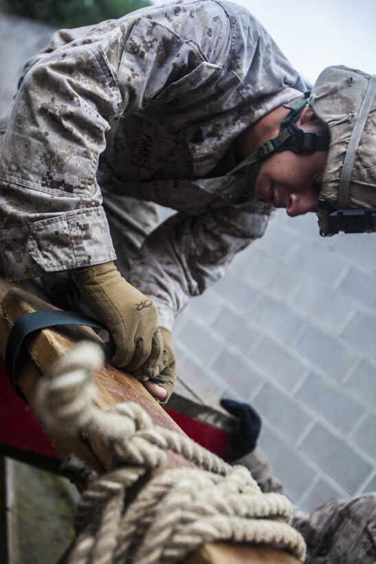 A U.S. Marine with Battalion Landing Team 1st Battalion, 6th Marine Regiment, 22nd Marine Expeditionary Unit (MEU), ties together a makeshift bridge to cross an obstacle during a leadership reaction course at Fort Pickett, Va., Aug. 27, 2013. The Marines completed the course in order to increase their small-unit leadership skills as part of the MEU’s Realistic Urban Training exercise. The MEU is scheduled to deploy in early 2014 to the U.S. 5th and 6th Fleet areas of responsibility with the Bataan Amphibious Ready Group as a sea-based, expeditionary crisis response force capable of conducting amphibious missions across the full range of military operations. (U.S. Marine Corps photo by Sgt. Austin Hazard/Released)