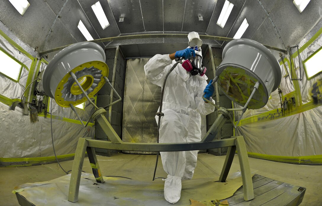 Airman 1st Class Eric Martinez uses a newly designed wheel workstation to paint a KC-135 Stratotanker wheel Aug. 27, 2013, at MacDill Air Force Base, Fla. The implementation of the WWS reduced the paint process time by 26 hours per set. Martinez is a structures technician assigned to the 6th Maintenance Squadron. (U.S. Air Force photo/Staff Sgt. Brandon Shapiro)