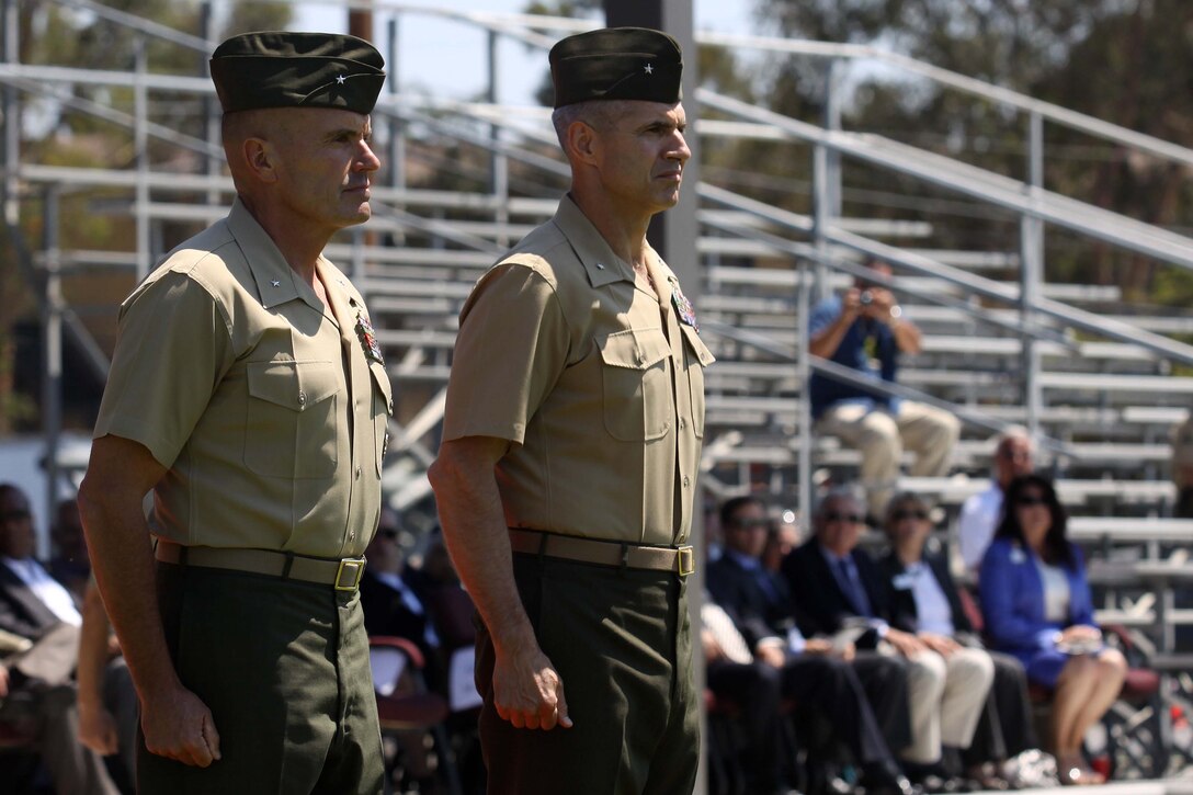 Brig. Gen. Vincent A. Coglianese relinquished authority to Brig. Gen. John Bullard during a change of command ceremony held at the 11 Area parade deck on Camp Pendleton, Aug. 23. "It is a truly wonderful experience to be back here at Camp Pendleton," said Bullard. "We are going ot keep up the fine traditions that Mary and Vinny have established, and we're going to continue to march forward."

