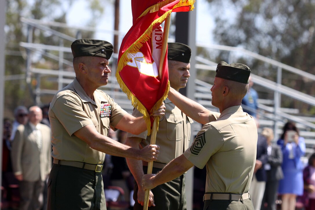 Brig. Gen. Vincent A. Coglianese relinquished authority to Brig. Gen. John Bullard during a change of command ceremony held at the 11 Area parade deck on Camp Pendleton, Aug. 23. "It is a truly wonderful experience to be back here at Camp Pendleton," said Bullard. "We are going ot keep up the fine traditions that Mary and Vinny have established, and we're going to continue to march forward."

