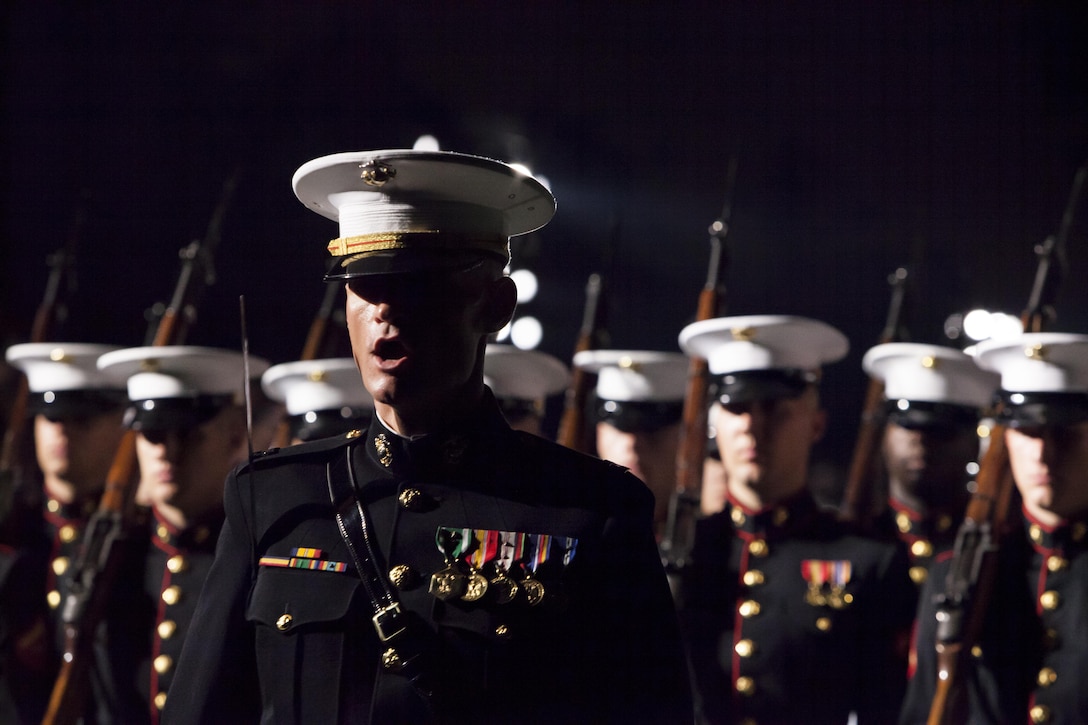 Capt. Carl A. Quist, a platoon commander with Marine Barracks Washington, D.C., calls a drill command while passing in review during the last Friday Evening Parade of the season at the Barracks Aug. 30. 