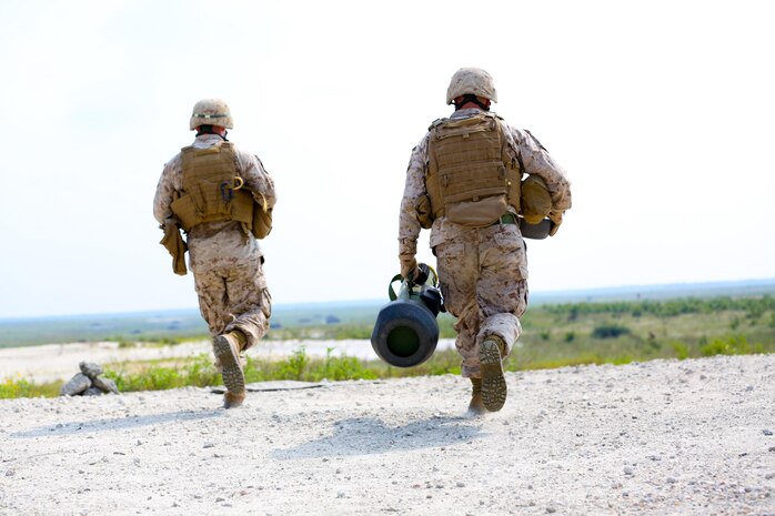 Sergeant Johnny Jernigan, an anti-tank missileman with 2nd Battalion, 9th Marine Regiment, from Whiteville, N.C., and Cpl. James Darius, also an anti-tank missileman with the unit, from Rally, N.C., run to the firing line to fire a FGM-148 Javelin during a live fire training exercise aboard Marine Corps Base Camp Lejeune, Aug. 29, 2013. With a single missile for the javelin costing approximately $80,000, it is not easy shooting all the time, said Chief Warrant Officer 2 Eric M. Brown, the battalion gunner, of Millwood, W.Va.