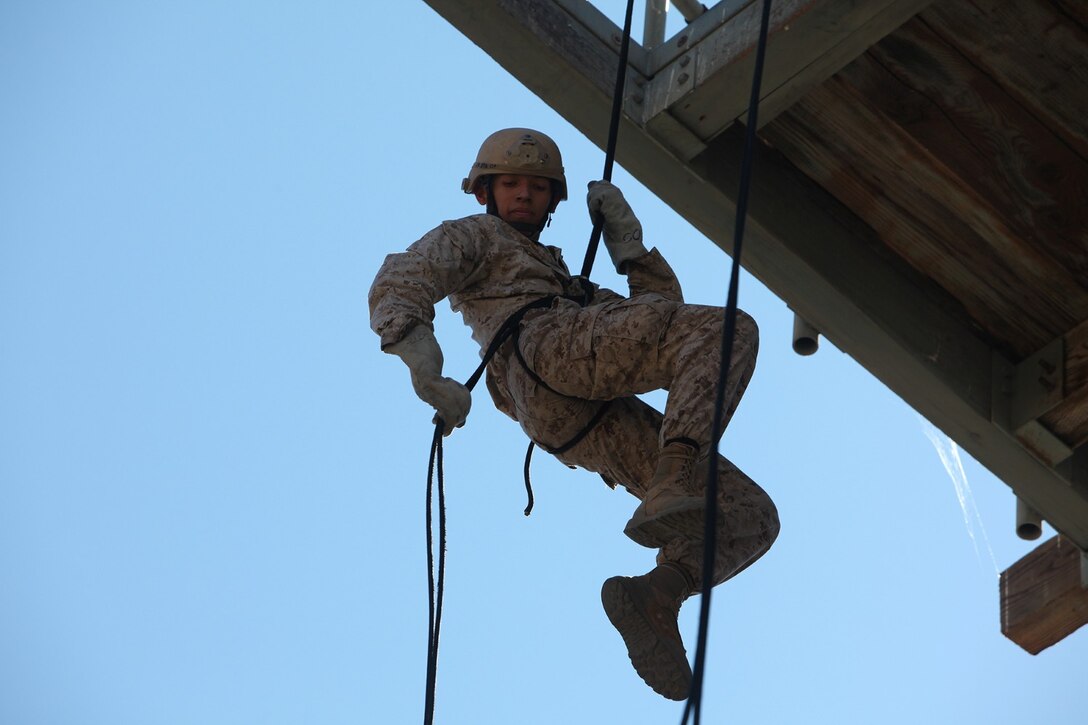 A Marine with 1st Air Naval Gunfire Liaison Company, rappels down a tower during joint training Exercise Burmese Chase aboard Camp Pendleton, Calif., Sept. 3, 2013. The training exercise was designed to increase confidence for team capabilities. (U.S. Marine Corps photo by Lance Cpl. Cody Haas/Released)