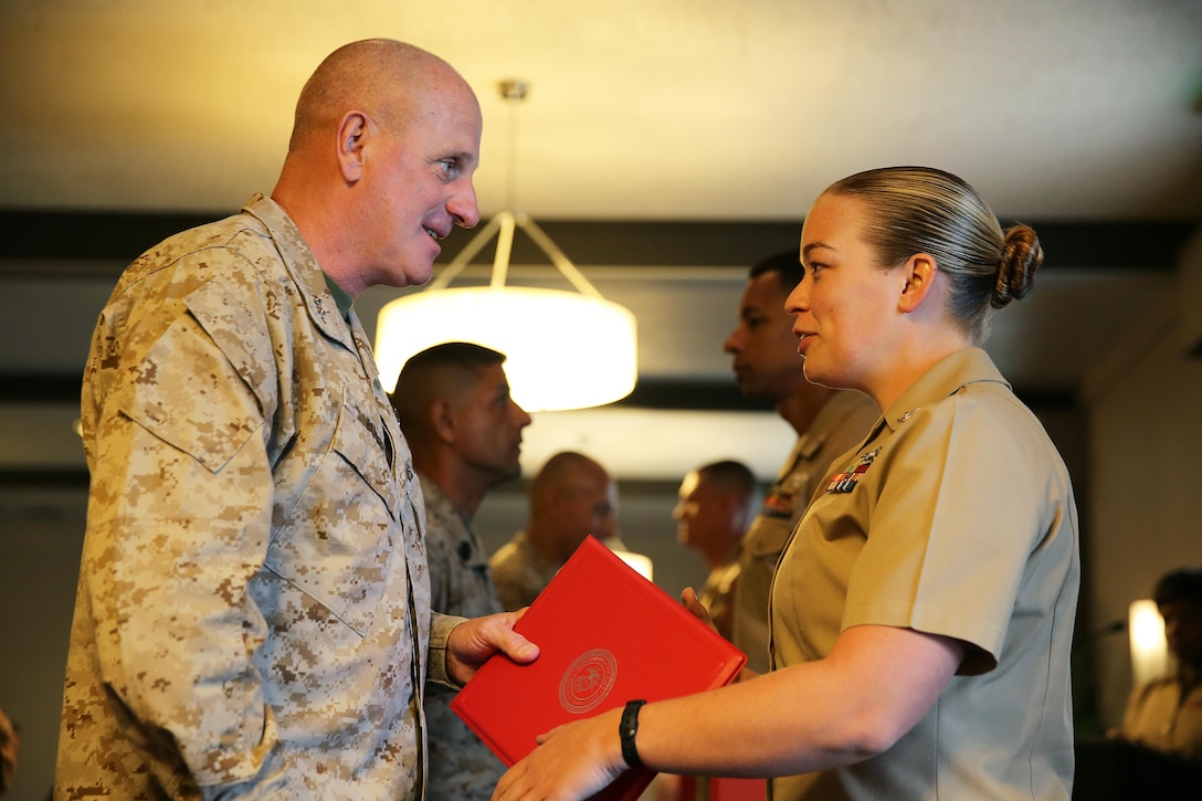 Petty Officer 2nd Class Emily Riley, a corpsman with Marine Heavy Helicopter Squadron 466 and a Dallas native, receives the 3rd Marine Aircraft Wing’s Junior Sailor of the Quarter Award from Maj. Gen. Steven Busby, 3rd MAW commanding general, aboard Marine Corps Air Station Miramar, Calif., Aug. 16.  Riley is highlighted as one of 3rd MAW’s outstanding leaders as part of Busby’s Committed and Engaged Leadership campaign.