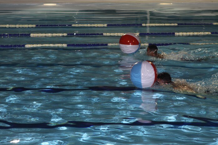 Participants race to the finish line during a Single Marine Program Pool Party Dolphin Relay Race at WaterWorks Outdoor Pool aboard Marine Corps Air Station Iwakuni, Japan, August 9, 2013. Single Marine Program hosts monthly events to entertain single and unaccompanied Marines.
