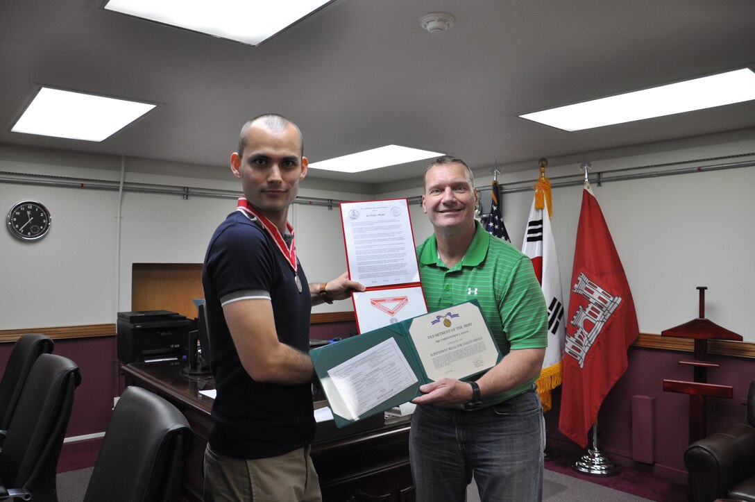 Deputy commander Lt. Col. John Rhodes presented an Achievement Medal for Civilian Service and a Steel De Fleury Medal to Christopher J. Shane who was recognized for superior meritorious service from August 12, 2012, to August 12, 2013, while serving as a logistics management Ssecialist in the Logistics Management Office, U.S. Army Corps of Engineers, Far East District. The de Fleury award is given to recognize superior service to the Engineer Regiment.  
http://www.armyengineer.com/aea_awards.html
