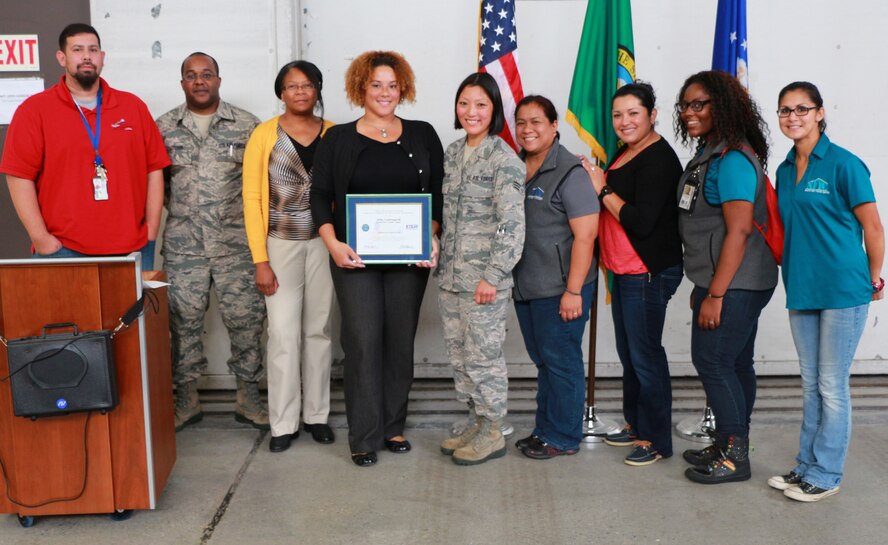Senior Master Sgt. Rob Cutchin (second from the left) and Senior Airman Tracy Bettendorf (middle) presented an Employee Support of the Guard and Reserve Patriot Award to Bettendorf's employer Aisha Laguer (fourth from the left) and the rest of the North Fort Youth Center Sept. 5 at Hangar 12. According to the ESGR website, the Patriot Award reflects the efforts made to support Citizen Warriors through a wide range of measures, including flexible schedules, time off prior to and after deployment, caring for families and granting leaves of absence if needed. Bettendorf has worked at the youth center for the last four and a half years and they have supported her for her last two and a half years as a Reservist. She nominated them for the award because of their support and understanding during her six months of orders. "I am responsible for creating and teaching science and woodworking curriculum for elementary-aged children at North Fort," she said. "There is a set time throughout the month that is devoted to writing the curriculum and cleaning the assigned room. North Fort management provided me with additional time to complete the summer curriculum, given I was on orders over the summer and had no time to accomplish it." (U.S. Air Force Reserve photo by Senior Airman Madelyn McCullough)