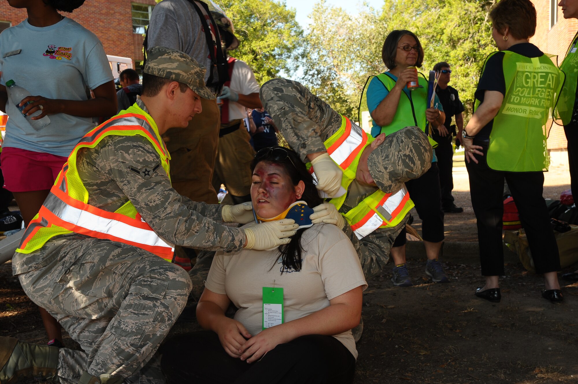 Members of the 14th Civil Engineer Squadron, 14th Security Forces Squadron and the 14th Medical Group traveled to the Mississippi University for Women Sept. 4 to assist in a campus emergency exercise. At exactly 8:22 p.m. two flash-bangs shook the campus and sent student actors(complete with gory makeup done by the 14th MDG)  tumbling to the ground. The Columbus Air Force Base Firefighters assisted with the “casualties” while the 14th Security Forces Squadron and the military working dogs cleared the buildings for explosives. (U.S. Air Force Photo/Airman 1st Class Stephanie Englar)