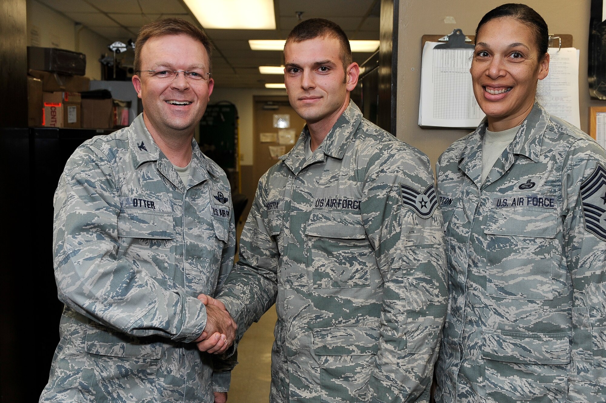 Staff Sgt. Richard Prestia, a 19th Communications Squadron airfield systems supervisor, receives a commander’s coin from Col. William Otter, 19th Airlift Wing vice commander, for his selection as Combat Airlifter of the Week Sept. 3, 2013, at Little Rock Air Force Base, Ark. Prestia led three major airfield systems upgrade projects valued at more than $730, 000 and decreased the work centers’ maintenance footprint by more than 100 hours annually. (U.S. Air Force photo by Staff Sgt. Russ Scalf)