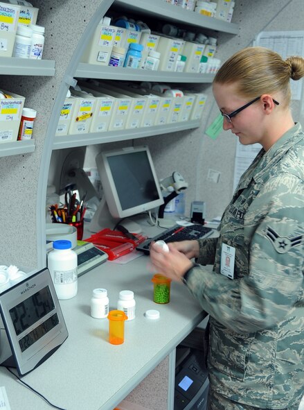Airman 1st Class Emily Klunk, 2nd Medical Group Pharmacy technician, fills a prescription on Barksdale Air Force Base, La., Aug. 22, 2013. Klunk is part of a two-person team that works nights at the 2nd MDG Satellite Pharmacy. This team helps to alleviate the burden of day shift by filling prescriptions, stocking shelves and more. (U.S. Air Force photo/Staff Sgt. Jason McCasland)