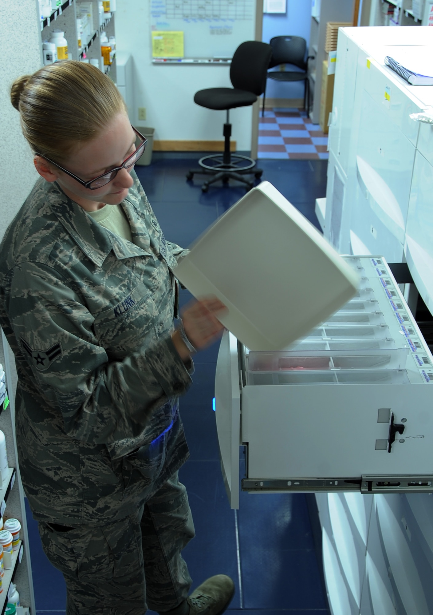 Airman 1st Class Emily Klunk, 2nd Medical Group Pharmacy technician, fills a medicine dispenser on Barksdale Air Force Base, La., Aug. 22, 2013. Klunk is one of two technicians who works the night shift, filling more than 500 refills prescriptions a night. (U.S. Air Force photo/Staff Sgt. Jason McCasland)