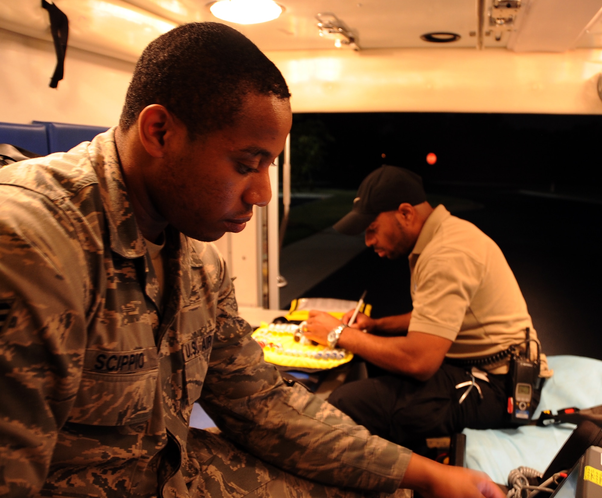 Senior Airman Christopher Scippio, 2nd Medical Group pharmacy emergency medical technician, and Robert Henderson, 2nd MDG paramedic, run inventory and equipment checks inside an ambulance on Barksdale Air Force Base, La., Aug. 26, 2013. Many units on base use night shifts to maintain the mission. The 2nd MDG uses night shift to save lives, no matter the emergency.  (U.S. Air Force photo/Staff Sgt. Jason McCasland)