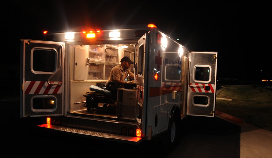 Robert Henderson, 2nd Medical Group paramedic, checks supplies and medicines in the ambulance on Barksdale Air Force Base, La., Aug. 26, 2013. Henderson is one of a two-person team that works during the night to respond to emergencies for Barksdale. Night shift, emergency medical teams help to save lives by responding to any location on base quickly. (U.S. Air Force photo/Staff Sgt. Jason McCasland)