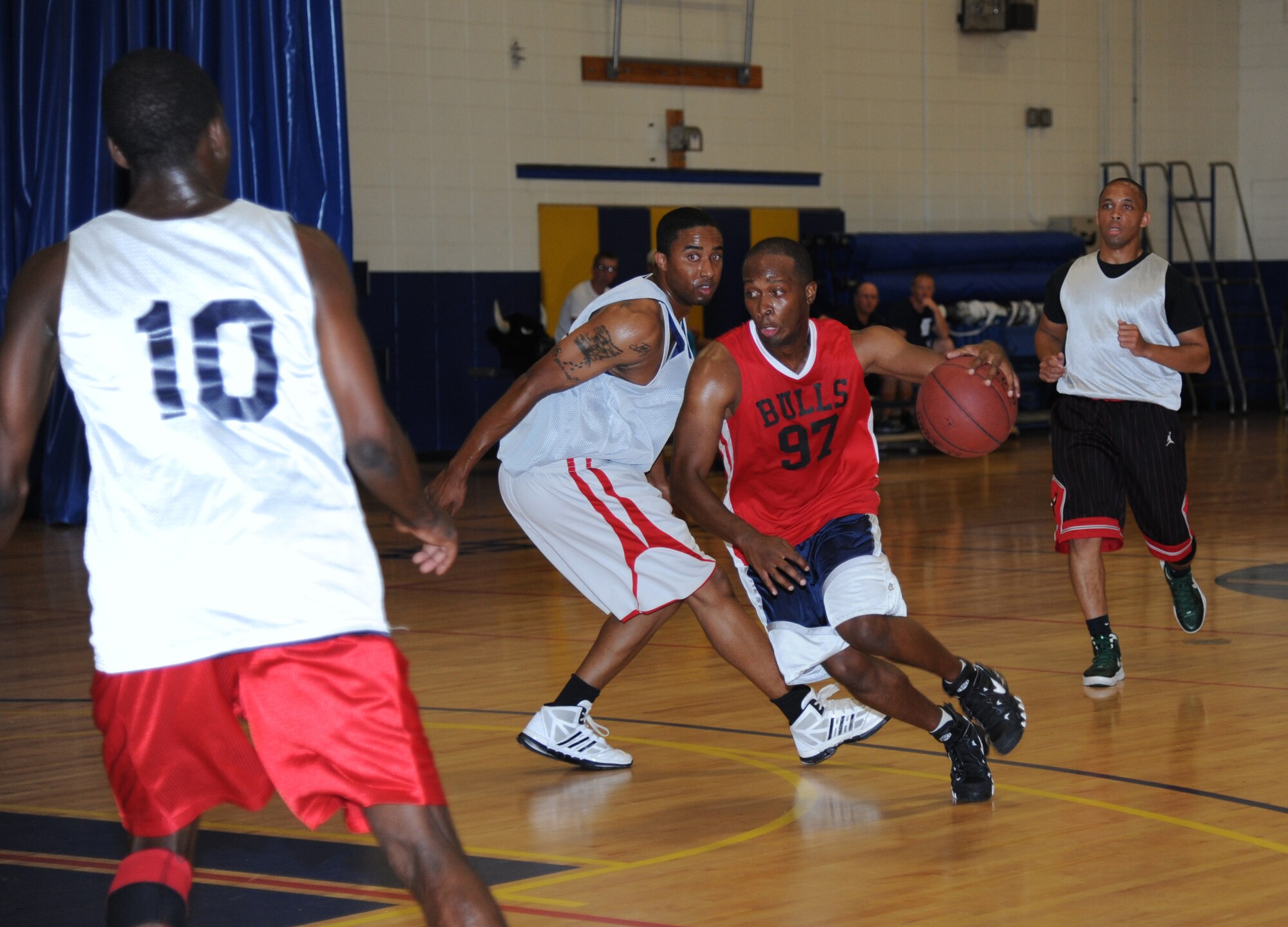 Javell Clay, 335th Training Squadron, dribbles the ball around Steph McCurdy, 81st Medical Group, during the intramural championship basketball game Sept. 4, 2013, Keesler Air Force Base, Miss. The81st MDG defeated the 335th TRS, 51-36.  (U.S. Air Force photo by Kemberly Groue)