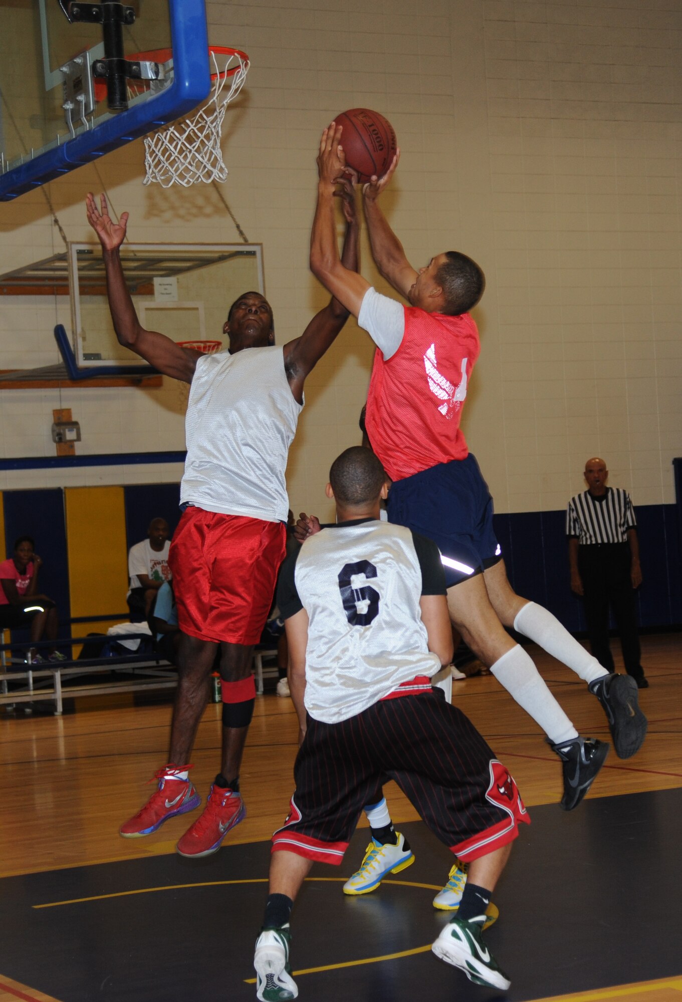 Ramon Thompson, 81st Medical Group, blocks Aaron Harrison, 335th Training Squadron, as he attempts to make a shot during the intramural championship basketball game Sept. 4, 2013, Keesler Air Force Base, Miss. The 81st MDG defeated the 335th TRS, 51-36.  (U.S. Air Force photo by Kemberly Groue)
