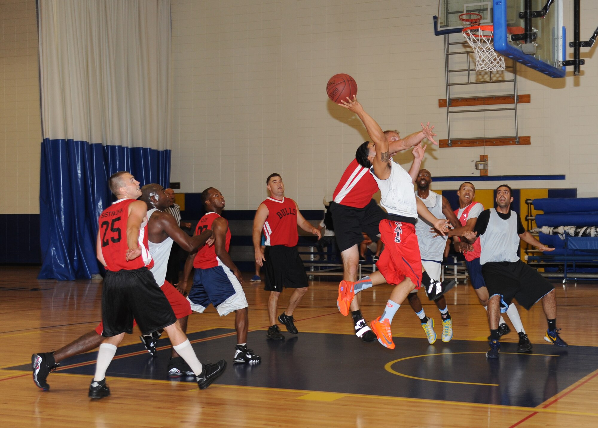 Mario McKnight, 81st Medical Group, goes up for two points as Adam Cook, 335th Training Squadron, attempts to block during the intramural championship basketball game Sept. 4, 2013, Keesler Air Force Base, Miss. The 81st MDG defeated the 335th TRS, 51-36.  (U.S. Air Force photo by Kemberly Groue)
