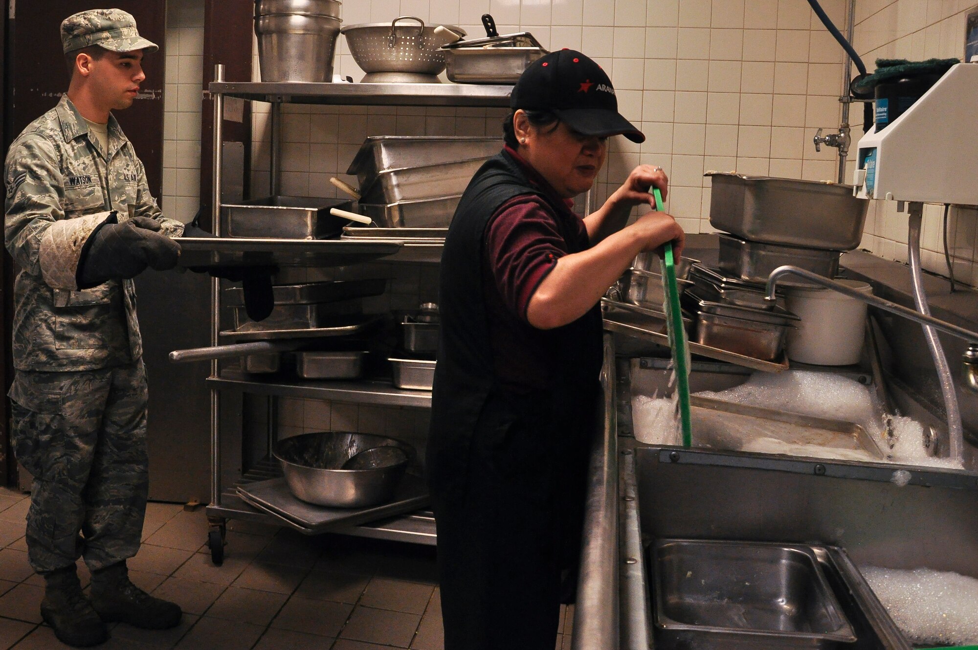 Ruth Walters, 19th Force Support Squadron food services assistant manager, washes dishes before lunch begins Aug. 21, 2013, at Little Rock Air Force Base, Ark. The dining facility hours are Monday through Sunday from 6:30 a.m. to 6:30 p.m. (U.S. Air Force photo by Senior Airman Regina Agoha) 
