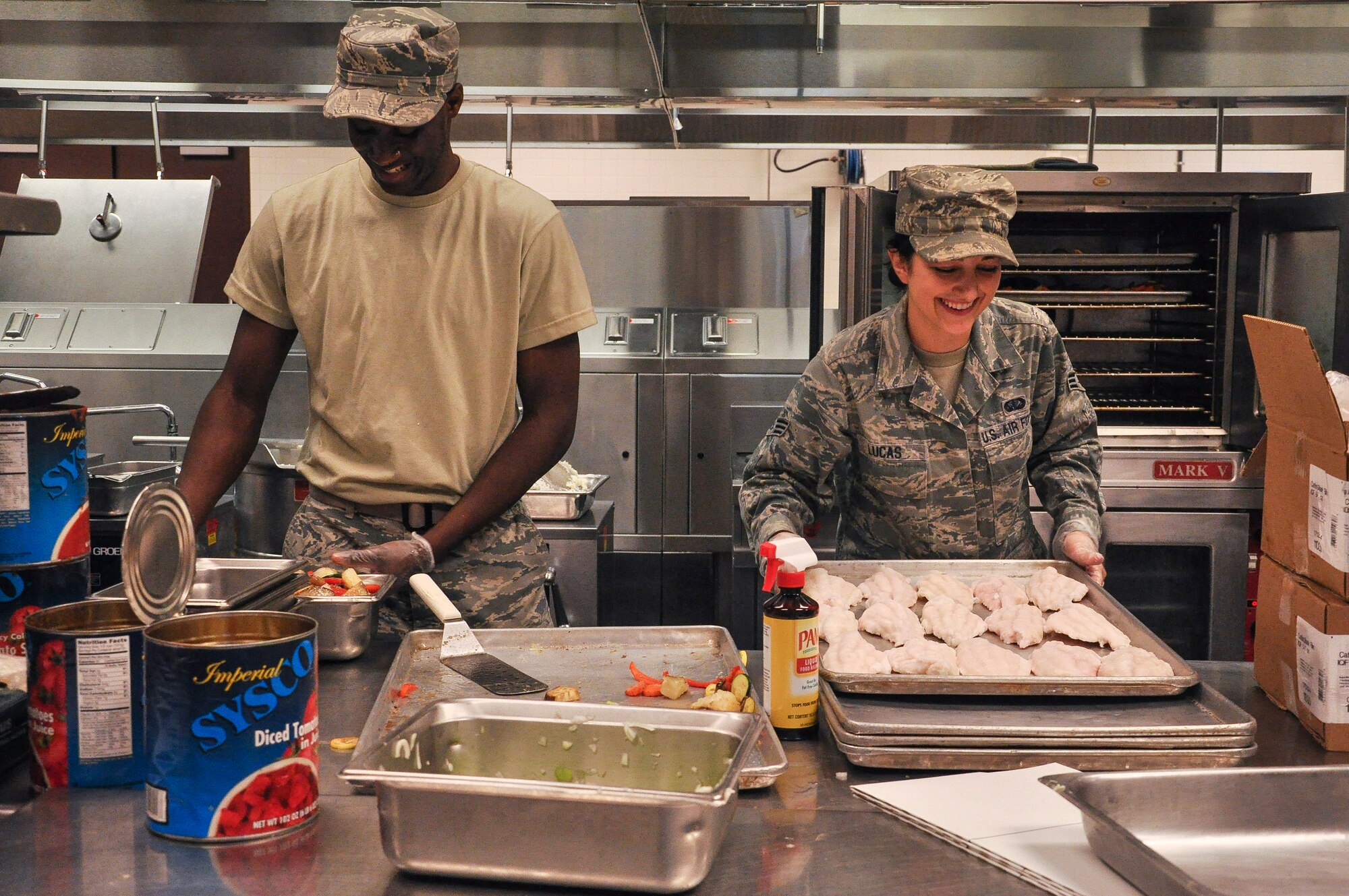 Senior Airman Malik Royal shares a laugh with Senior Airman Heather Lucas, both 19th Force Support Squadron personnel, Aug. 21, 2013, at Little Rock Air Force Base. The dining facility hours are Monday through Sunday from 6:30 a.m. to 6:30 p.m. (U.S. Air Force photo by Senior Airman Regina Agoha)