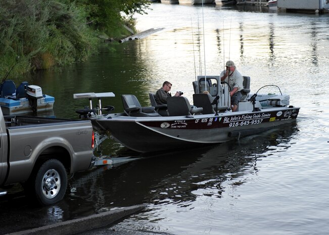 A Beale Wounded Warrior and his son prepare for a day of fishing during a fishing tournament on the      Sacramento River near North Sacramento Calif., Aug. 24, 2013. Balfour Beatty hosted the tourney to promote Beale’s Wounded Warriors. (U.S. Air Force photo by Staff Sgt. Robert M. Trujillo/Released)