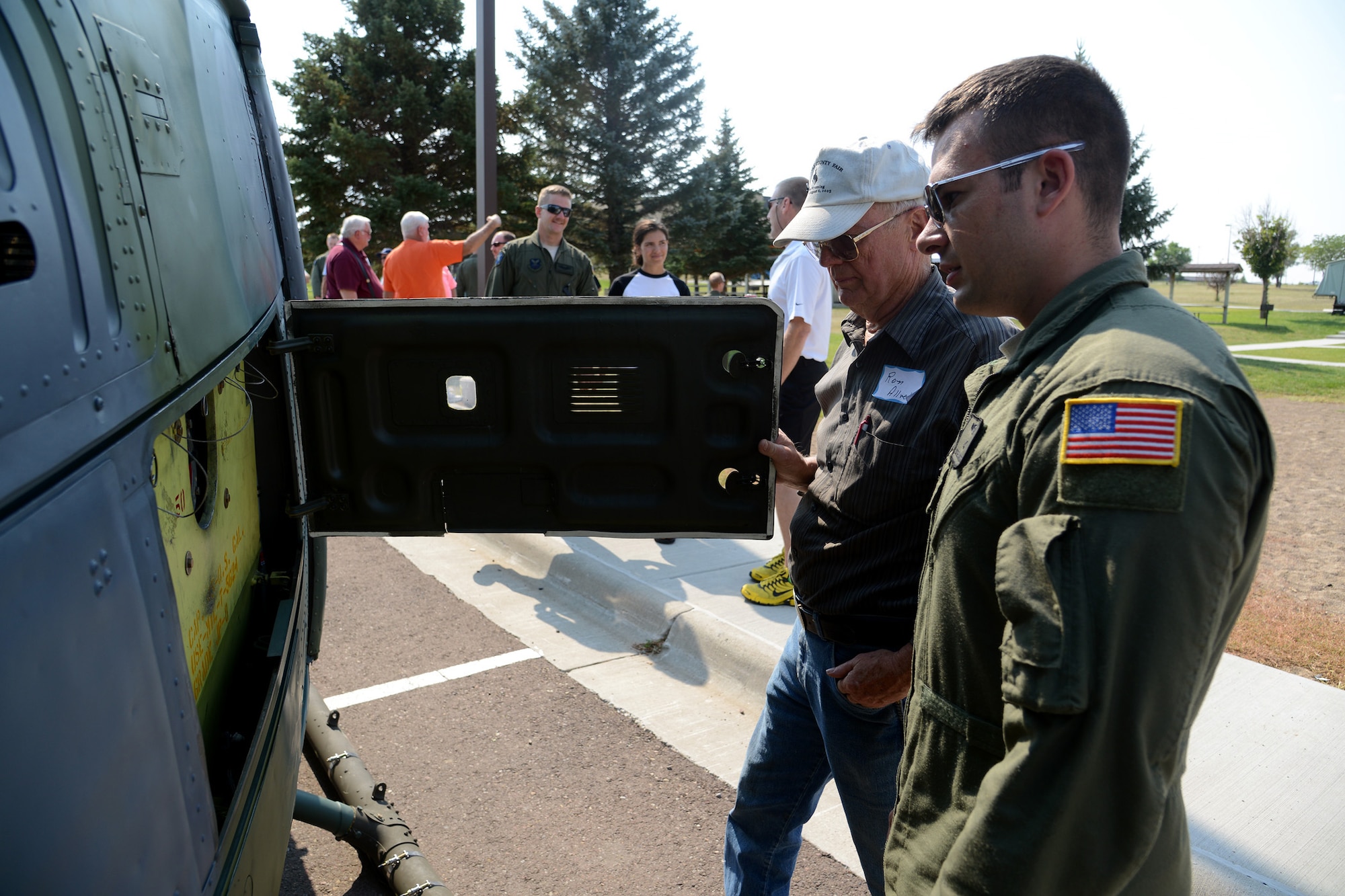 Staff Sgt. Blake Cooper, a 40th Helicopter Squadron UH-1N Huey helicopter flight engineer, shows Leron Allred “under the hood” of a UH-1N Huey helicopter during a tour Aug. 27 at Sun Plaza Park. Allred served as a Sikorsky CH-3C helicopter pilot in the 20th Helicopter Squadron during the Vietnam War. (U.S. Air Force photo/Staff Sgt. R.J. Biermann)