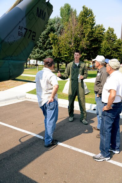 First Lt. Andrew Perroni, a 40th Helicopter Squadron UH-1N Huey helicopter pilot, explains the mission of the squadron to tour attendees Aug. 27 at Sun Plaza Park. The squadron hosted the 20th Helicopter Squadron reunion group, which included 27 retired or veteran Airmen and their families. (U.S. Air Force photo/Staff Sgt. R.J. Biermann)