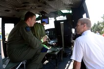 Staff Sgt. Justin Nissen, 40th Helicopter Squadron NCO in charge of current operations, shows Ken Coburn the inside of a UH-1N Huey helicopter. Coburn’s father, Master Sgt. (Ret.) Joe Corburn, was a former 20th Helicopter Squadron Sikorsky CH-3C helicopter flight engineer (U.S. Air Force photo/Staff Sgt. R.J. Biermann)
