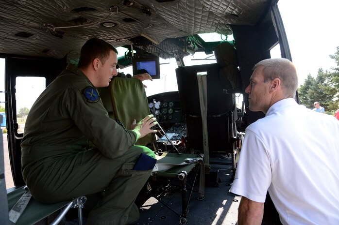 Staff Sgt. Justin Nissen, 40th Helicopter Squadron NCO in charge of current operations, shows Ken Coburn the inside of a UH-1N Huey helicopter. Coburn’s father, Master Sgt. (Ret.) Joe Corburn, was a former 20th Helicopter Squadron Sikorsky CH-3C helicopter flight engineer (U.S. Air Force photo/Staff Sgt. R.J. Biermann)