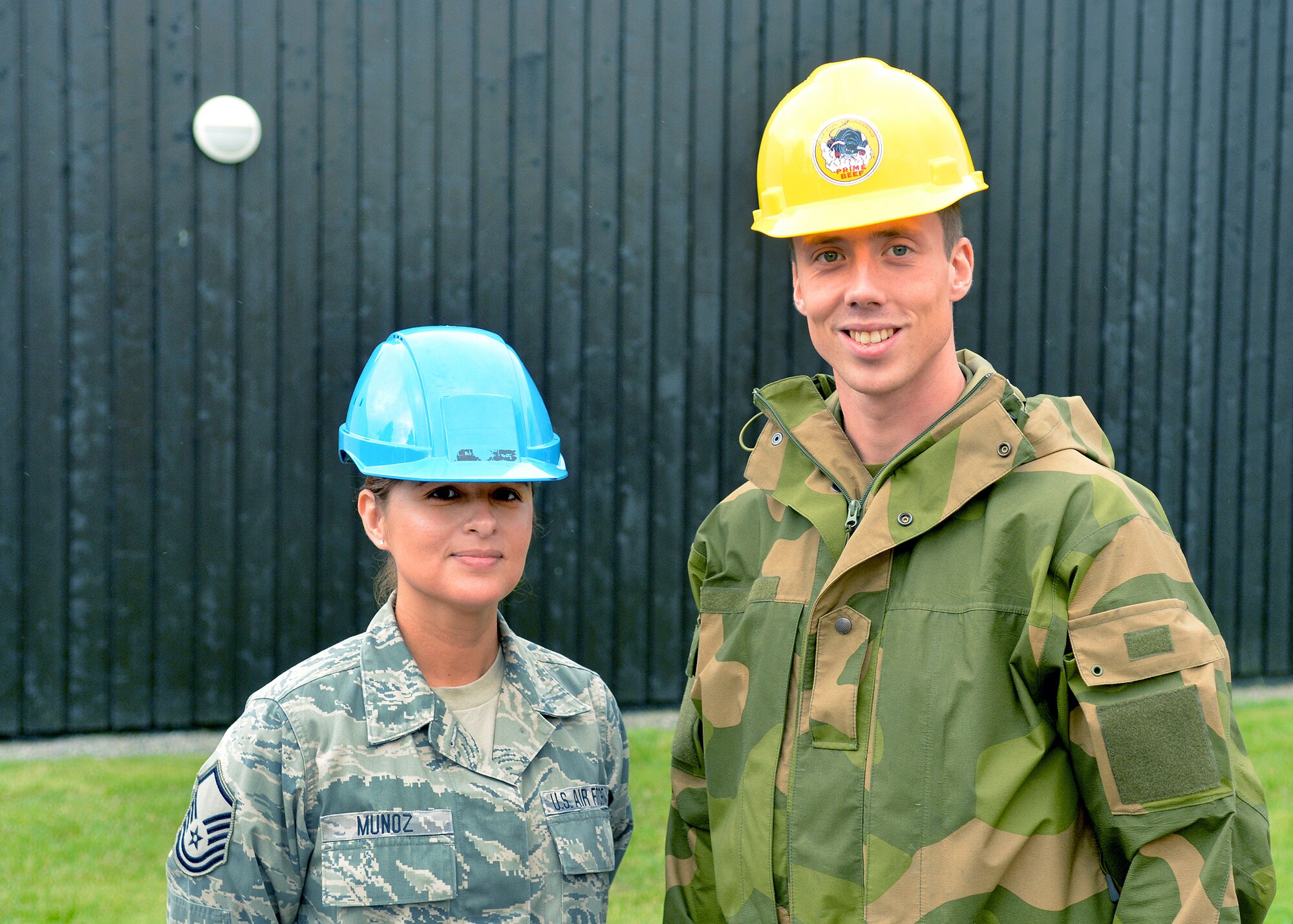 U.S. Air Force Master Sgt. Rosario Muñoz (left), a water and fuels systems maintenance supervisor with the Texas Air National Guard’s 149th Civil Engineering Squadron, a subordinate unit of the 149th Fighter Wing, based at Joint Base San Antonio – Lackland, Texas, stands with Cadet Kent Bakke (right), a senior Royal Norwegian military cadet enrolled in the engineering program at the Norwegian Military Academy (Krigsskolen), at Camp Linderud, in Oslo, Norway, Aug. 16, 2013. The 149th Fighter Wing’s 149th Civil Engineering Squadron was in Norway as part of the National Guard Bureau’s deployment for training (DFT) program to train with members of the Royal Norwegian armed forces. Muñoz and Bakke served as project managers for the Texas and Norwegian teams, respectively, and traded their hardhats for the photo. (U.S. Air National Guard photo by Staff Sgt. Phil Fountain / Released)
