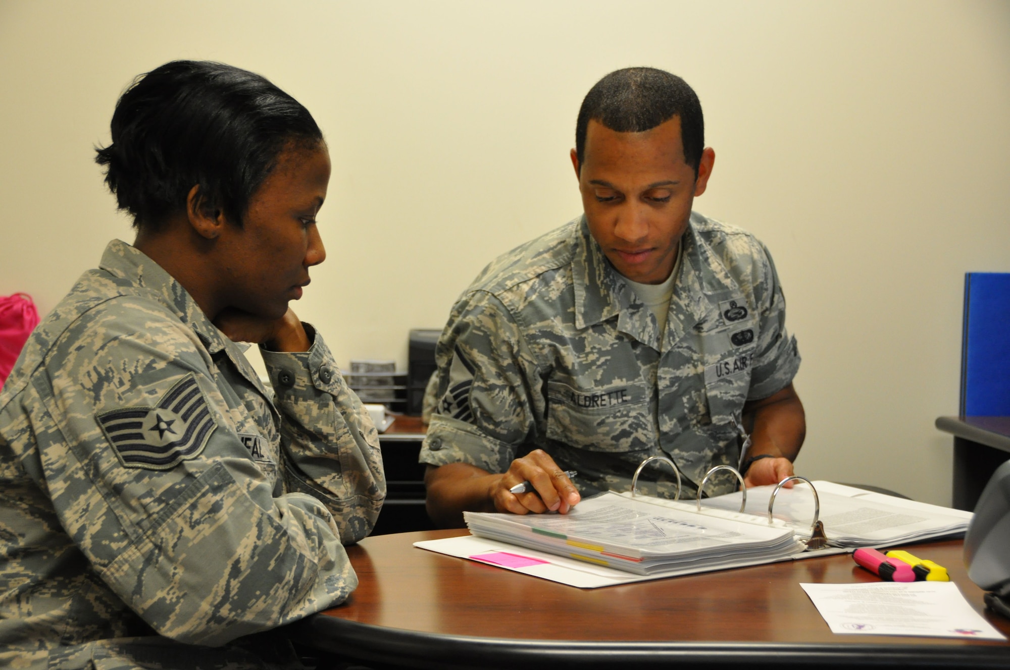 Master Sgt. Mark Aldrette, 50 IS, and Tech. Sgt. Yaschica O’Neal, 792 ISS, read through a Master Training Plan at JB Pearl Harbor-Hickam, Hawaii. Aldrette, the 50 IS Education and Training Manager, helped standardize the 792 ISS training program for an upcoming inspection during his two week annual tour. (U.S. Air Force Photo/Capt. Joe Simms)