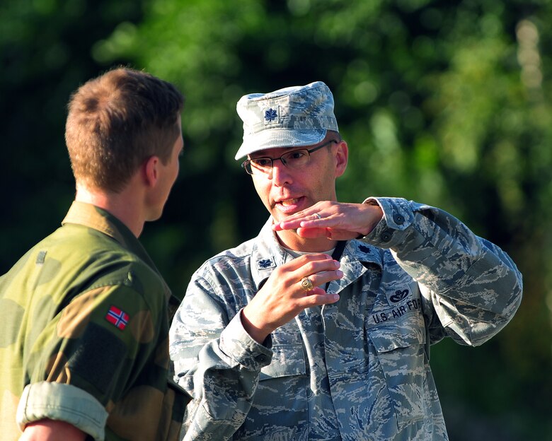 U.S. Air Force Lt. Col. Christopher A. Miller (right), commander of the Texas Air National Guard’s 149th Civil Engineering Squadron, a subordinate unit of the 149th Fighter Wing, based at Joint Base San Antonio – Lackland, Texas, talks with Cadet Kent Bakke (left), a senior Royal Norwegian military cadet enrolled in the engineering program at the Norwegian Military Academy (Krigsskolen), at Camp Linderud, in Oslo, Norway, at Rygge Air Station, Norway, Aug. 14, 2013. Miller, a graduate of Texas A&M University, in College Station, Texas, was in Norway with the 149th Fighter Wing’s 149th Civil Engineering Squadron as part of the National Guard Bureau’s deployment for training (DFT) program to train with members of the Royal Norwegian armed forces. (U.S. Air National Guard photo by Senior Master Sgt. Miguel Arellano / Released)