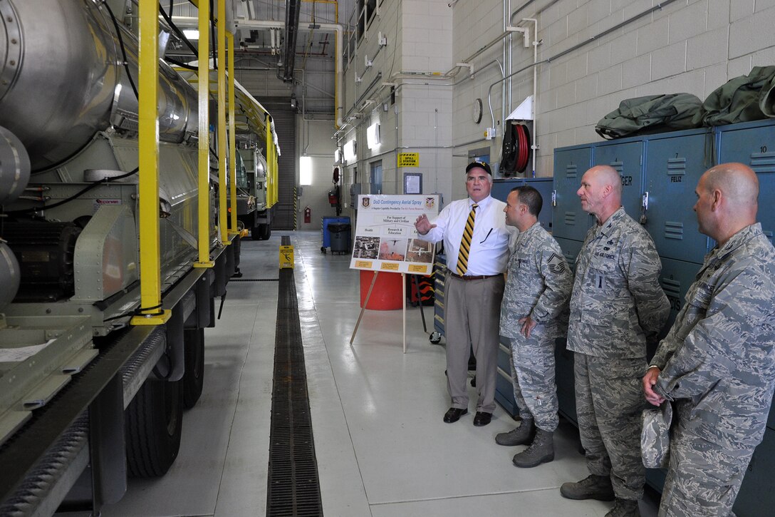 YOUNGSTOWN AIR RESERVE STATION, Ohio – Air Force Reserve Senior Master Sgt. Phil Aliberti (second from left), 910th Aerial Spray Maintenance Chief, listens as Congressman Mike Kelly (left with hat) of Pennsylvania’s third district, asks a question about the Modular Aerial Spray System (MASS) sitting on the nearby trailer (far left) in the aerial spray maintenance hangar here, Sept. 4, 2013. Col. David Post (second from right), 910th Maintenance Group commander, and Col. James Dignan (right), 910th Airlift Wing commander, also listened in as Aliberti briefed the congressman on the unit’s unique capability. The 910th Airlift Wing is home to the Department of Defense’s only aerial spray squadron. The congressman visited YARS to learn more about the wing’s mission and the installation’s features firsthand as well as meet some of the Citizen Airmen assigned here.