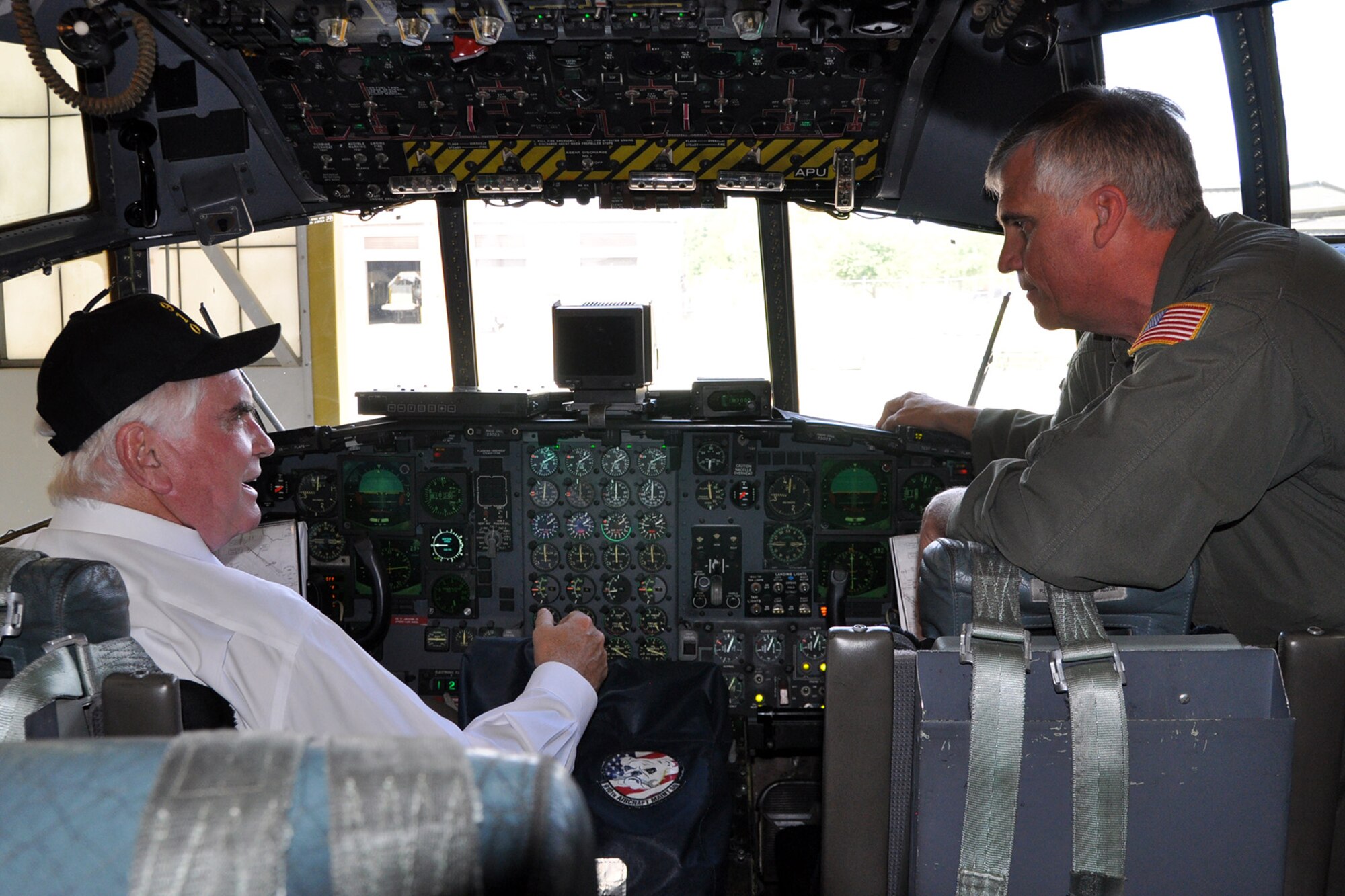 YOUNGSTOWN AIR RESERVE STATION, Ohio – Air Force Reserve Col. Bill Phillips (right), commander of the 910th  Operations Group, based here, talks with Congressman Mike Kelly (left) of Pennsylvania’s third district about aircraft capabilities on the flight deck of a C-130 Hercules cargo aircraft in a hangar here, Sept. 4, 2013. The congressman visited YARS to learn more about the wing’s capabilities and the installation’s features firsthand as well as meet some of the Citizen Airmen assigned here.