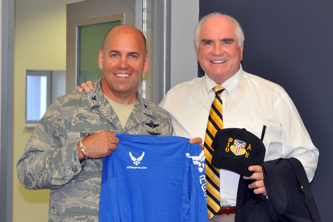 YOUNGSTOWN AIR RESERVE STATION, Ohio – Air Force Reserve Col. James Dignan, commander of the 910th Airlift Wing, based here shows off a tee shirt and hat he presented to Congressman Mike Kelly (right) of Pennsylvania’s third district during a visit to the air station, Sept. 4, 2013. The congressman visited YARS to learn more about the wing’s capabilities and the installation’s features firsthand as well as meet some of the Citizen Airmen assigned here.