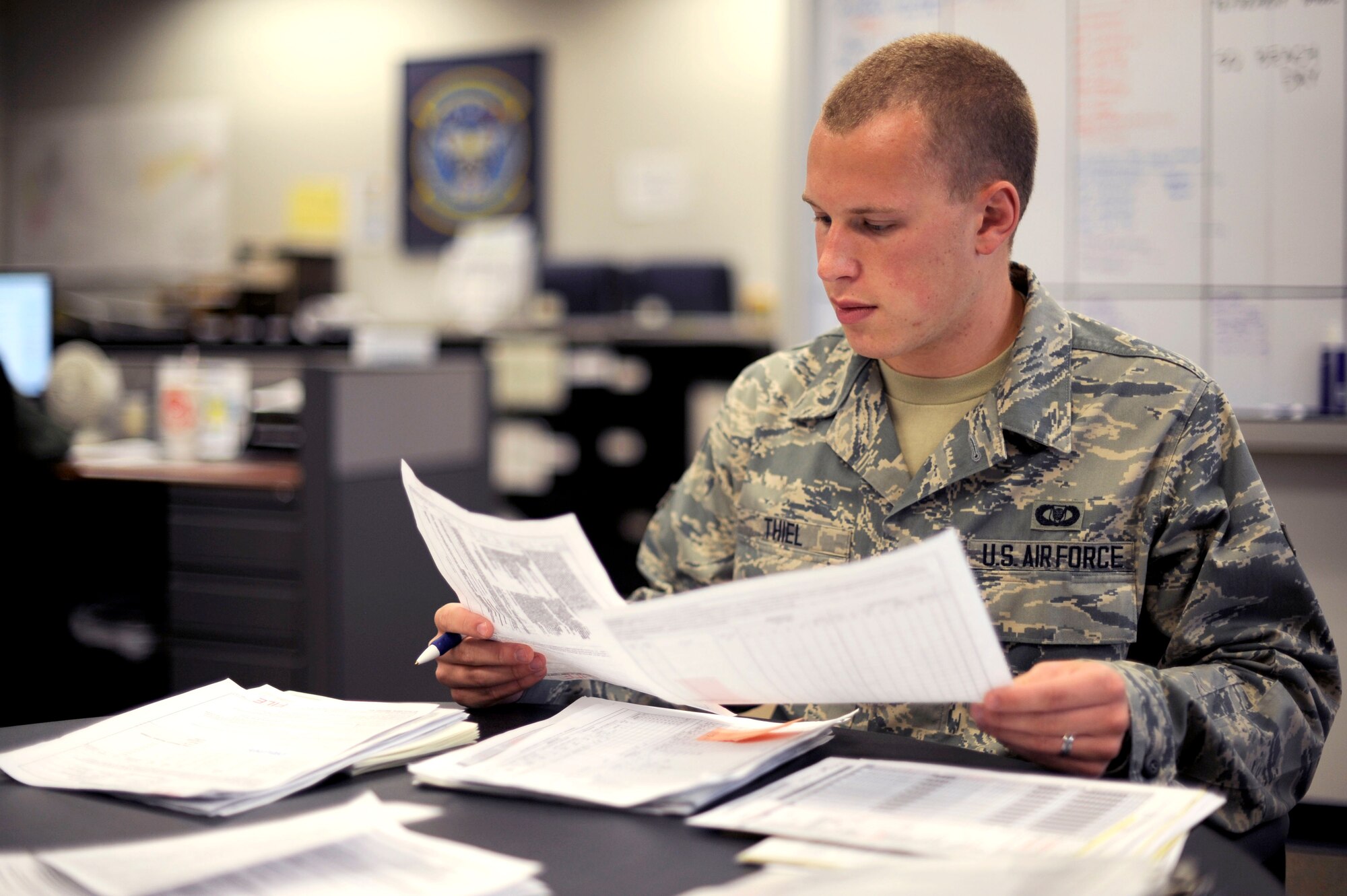 Airman 1st Class Daniel Thiel, 32nd Air Refueling Squadron aviation resource manager, reviews air crew training documents Aug. 29, 2013, at Joint Base McGuire-Dix-Lakehurst, N.J. Thiel, a Chicago native, is responsible for tracking all air crew training requirements and ensuring they are fully qualified before each mission. (U.S. Air Force Photo by Tech. Sgt. Darrell Dean/Released)