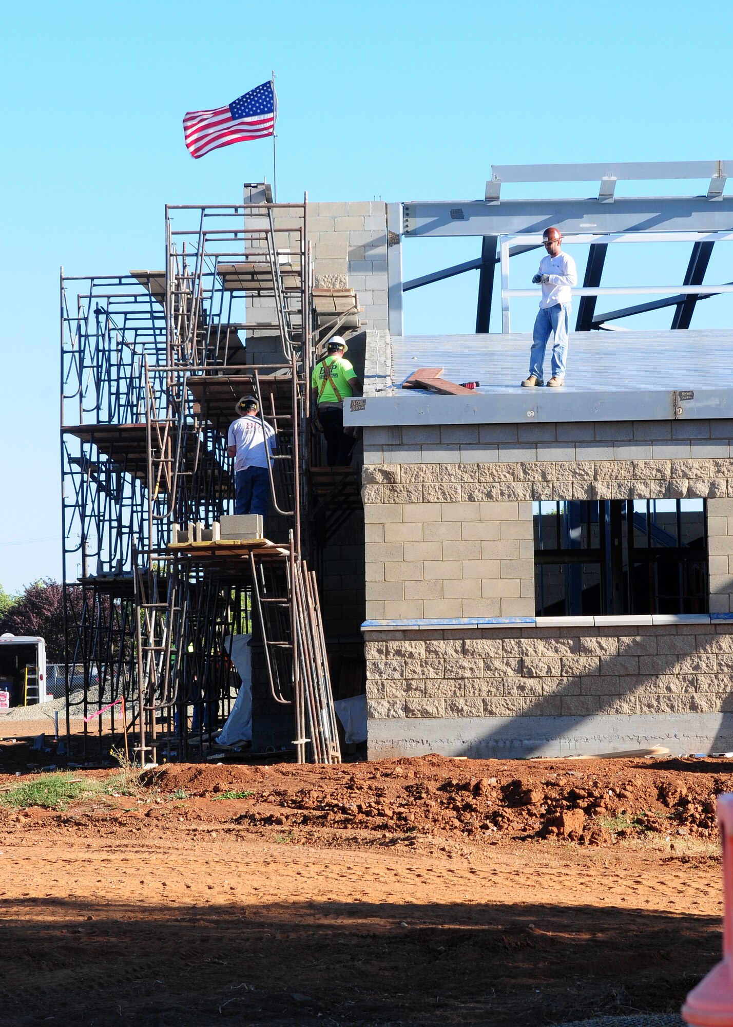 Contractors work on the new Wing Operations & Training Facility for the 162nd Combat Communications Group at Beale Air Force Base, Calif., Sept. 5, 2013. The 10,800-square foot single story building is scheduled to be completed in May 2014. (U.S. Air Force photo by Senior Airman Allen Pollard/Released)