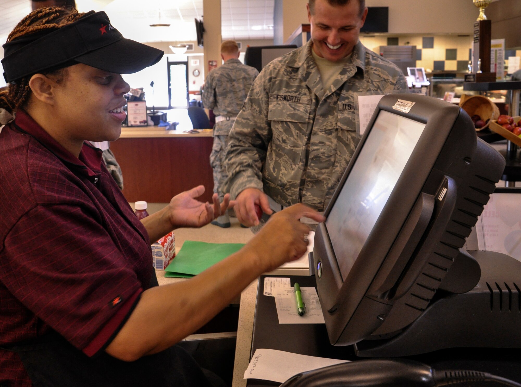 Barbie Jackson, a 19th Force Support Squadron food services employee, converses with a customer Aug. 21, 2013, at Little Rock Air Force Base, Ark. The dining facility hours are Monday through Sunday from 6:30 a.m. to 6:30 p.m. (U.S.  Air Force photo by Senior Airman Regina Agoha)