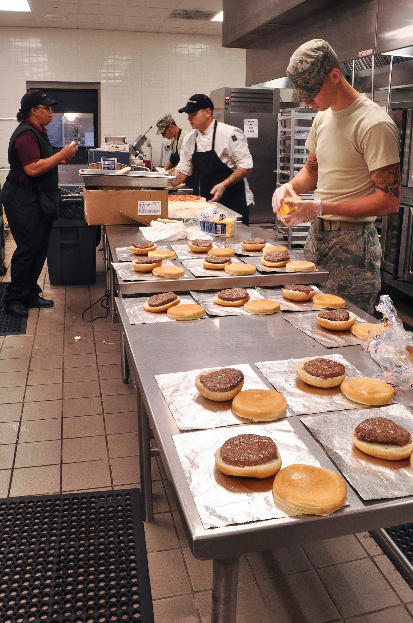 Airmen and Aramark food service employees from the 19th Force Support Squadron prepare lunch for the Hercules Dining Facility Aug. 19, 2013, at Little Rock Air Force Base, Ark. The dining facility hours are Monday through Sunday from 6:30 a.m. to 6:30 p.m. (U.S.  Air Force photo by Senior Airman Regina Agoha)