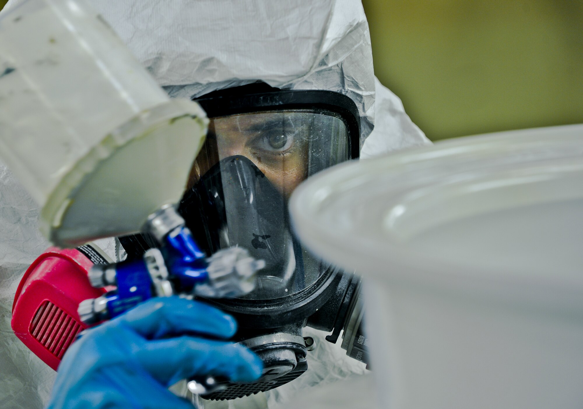 Airman 1st Class Eric Martinez, 6th Maintenance Squadron aircraft structural maintenance technician, paints a KC-135 Stratotanker wheel on Aug 27, 2013, MacDill Air Force Base, Fla. The wheels were sent to the paint shop for a new application of a corrosion preventative coating. (U.S. Air Force photo/Staff Sgt. Brandon Shapiro/Released)