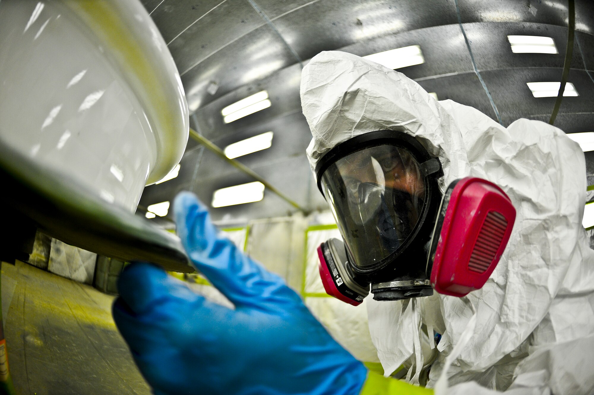 Airman 1st Class Eric Martinez, 6th Maintenance Squadron aircraft structural maintenance technician, inspects a fresh coat of paint on Aug 27, 2013, MacDill Air Force Base, Fla. Martinez's paintjob was applied to a set of KC-135 Stratotanker wheels that needed a new corrosion preventative coating. (U.S. Air Force photo/Staff Sgt. Brandon Shapiro/Released)