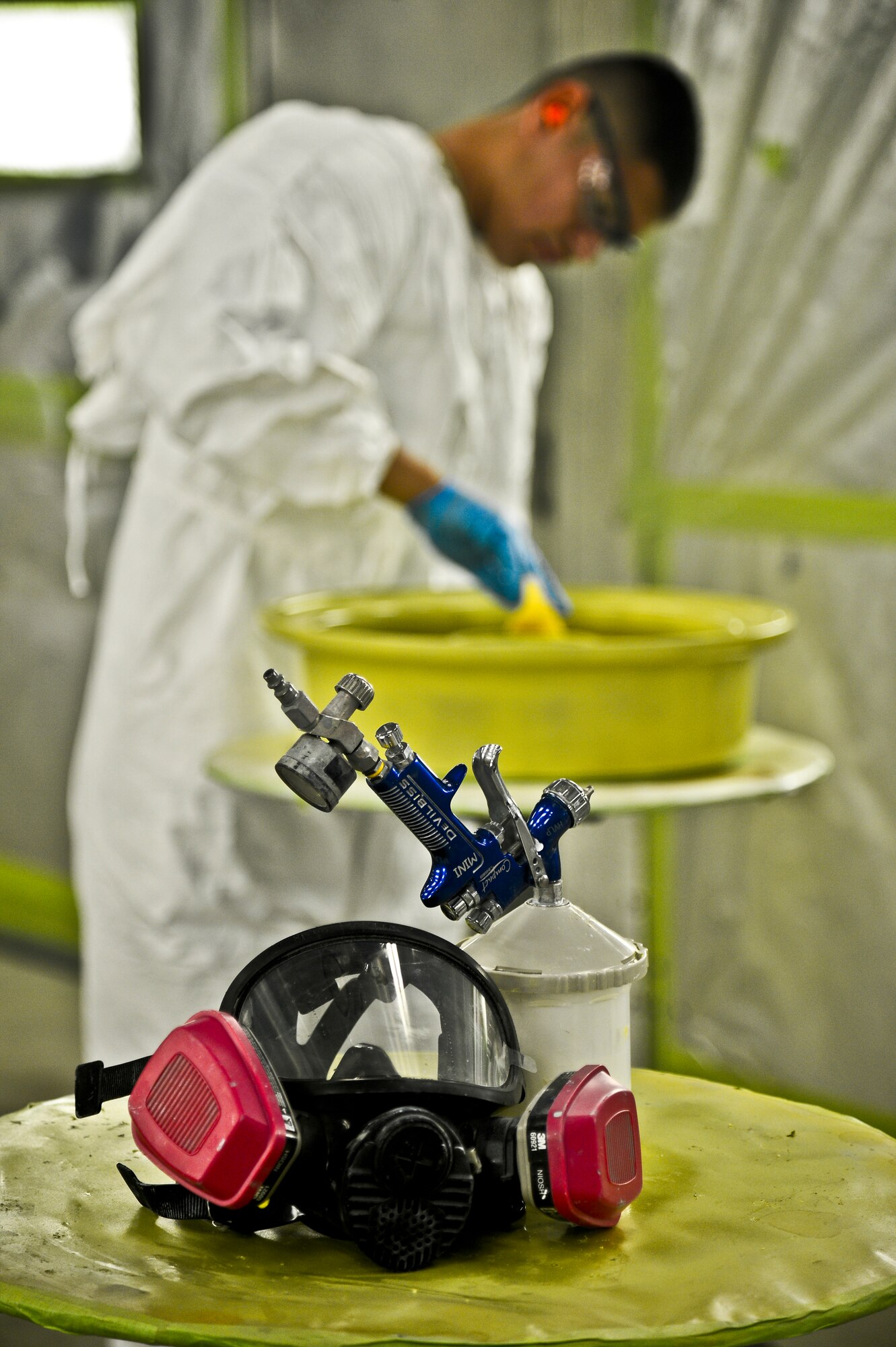 Airman 1st Class Eric Martinez, 6th Maintenance Squadron aircraft structural maintenance technician, preps a wheel prior to painting on Aug 27, 2013, MacDill Air Force Base, Fla. Martinez painted a set of KC-135 Stratotanker wheels that needed a new corrosion preventative coating. (U.S. Air Force photo/Staff Sgt. Brandon Shapiro/Released)
