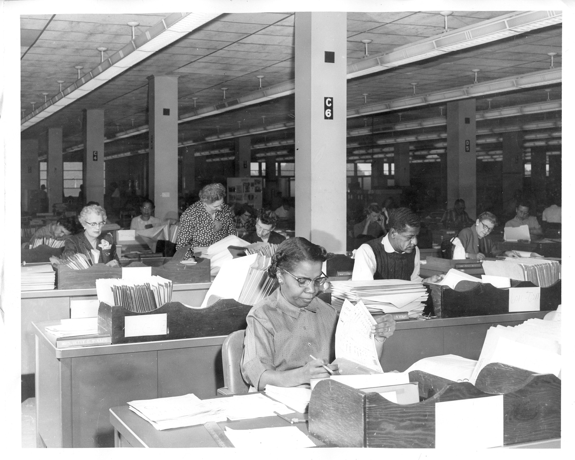 Employees at the Air Reserve Records Center working at their desks at the York Street building, Denver, Colo., in the 1950s. Employees did not have telephones or computers at their desks and by 1958, the center was responsible for nearly 500,000 records.