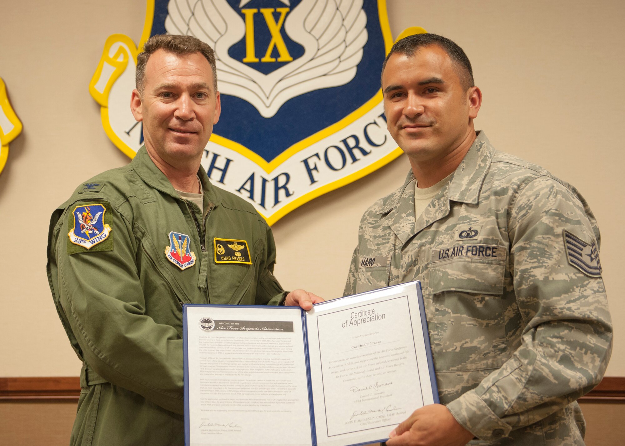 U.S. Air Force Col. Chad Franks, 23d Wing commander, is presented with a certificate of appreciation and Air Force Sergeants Association (AFSA) membership from Tech. Sgt. Steven Haro, Moody AFSA Chapter 460 president, at Moody Air Force Base, Ga., Sept. 4, 2013. The Moody AFSA Chapter 460 thanked Franks for his continued support for the enlisted force. (U.S. Air Force photo by Senior Airman Eileen Meier/Released)