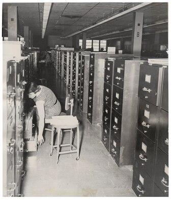 An Air Reserve Records Center employee files records in the file cabinet bank at the York Street building, Denver, Colo., in 1955. ARRC officially opened its doors March 1, 1954, almost 60 years ago. It wasn't until Sept. 1, 1965, that it was renamed the Air Reserve Personnel Center due to increasing involvement in all areas of personnel management and not only records. ARPC will celebrate their 60th birthday on Feb. 28, 2014. (U.S. Air Force photo)

