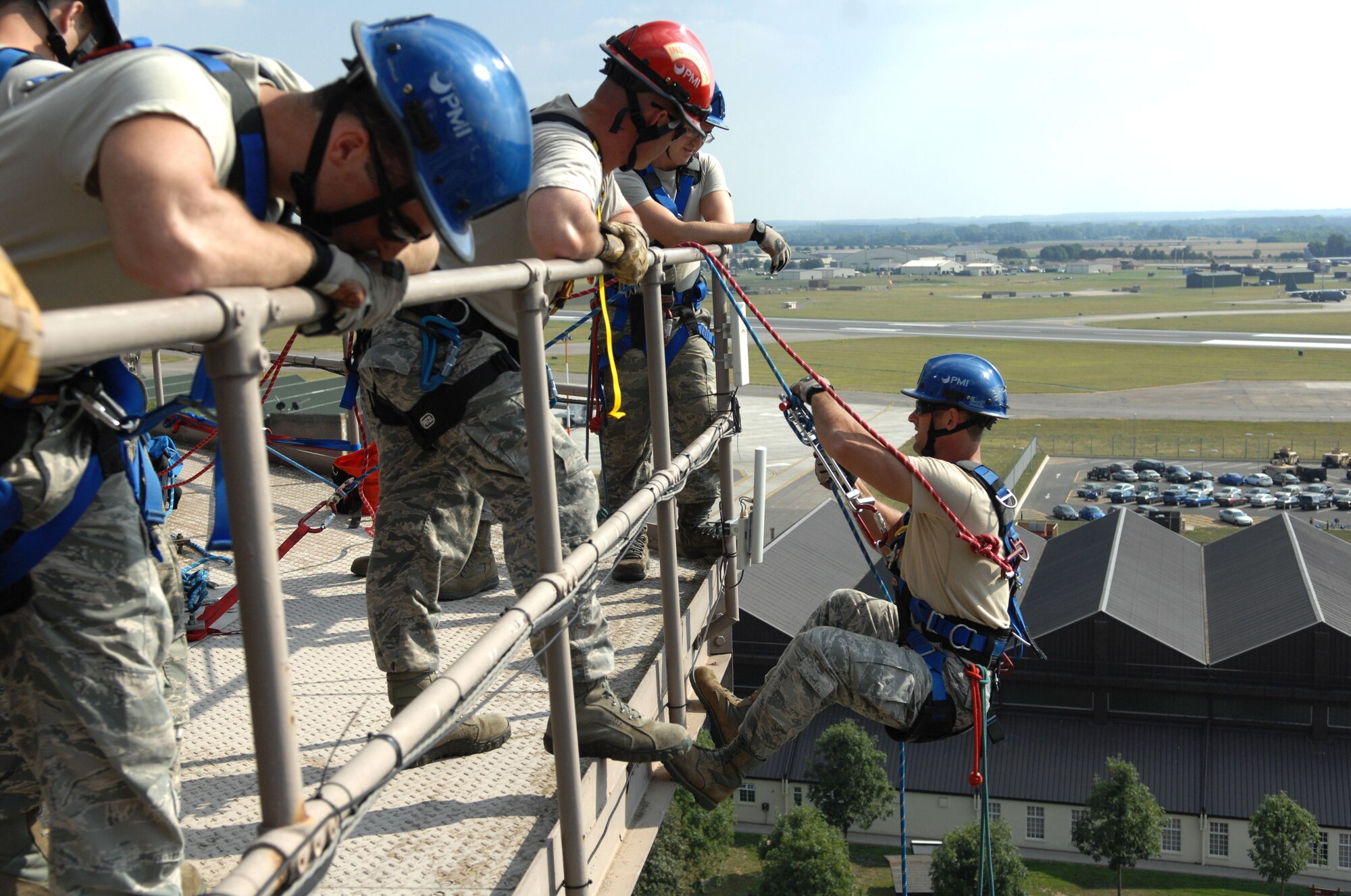 U.S. Air Force Senior Airman Brandon Ah You, right, 100th Civil Engineer Squadron Fire Department firefighter from Thousand Oaks, Calif., begins to rappel Sept. 4, 2013, on RAF Mildenhall, England. Firefighters must train to be able to safely extract victims from any situation. The rappelling was part of the high-angle portion of the firefighters’ technical rope rescue course. (U.S. Air Force photo by Airman 1st Class Dillon Johnston/Released)