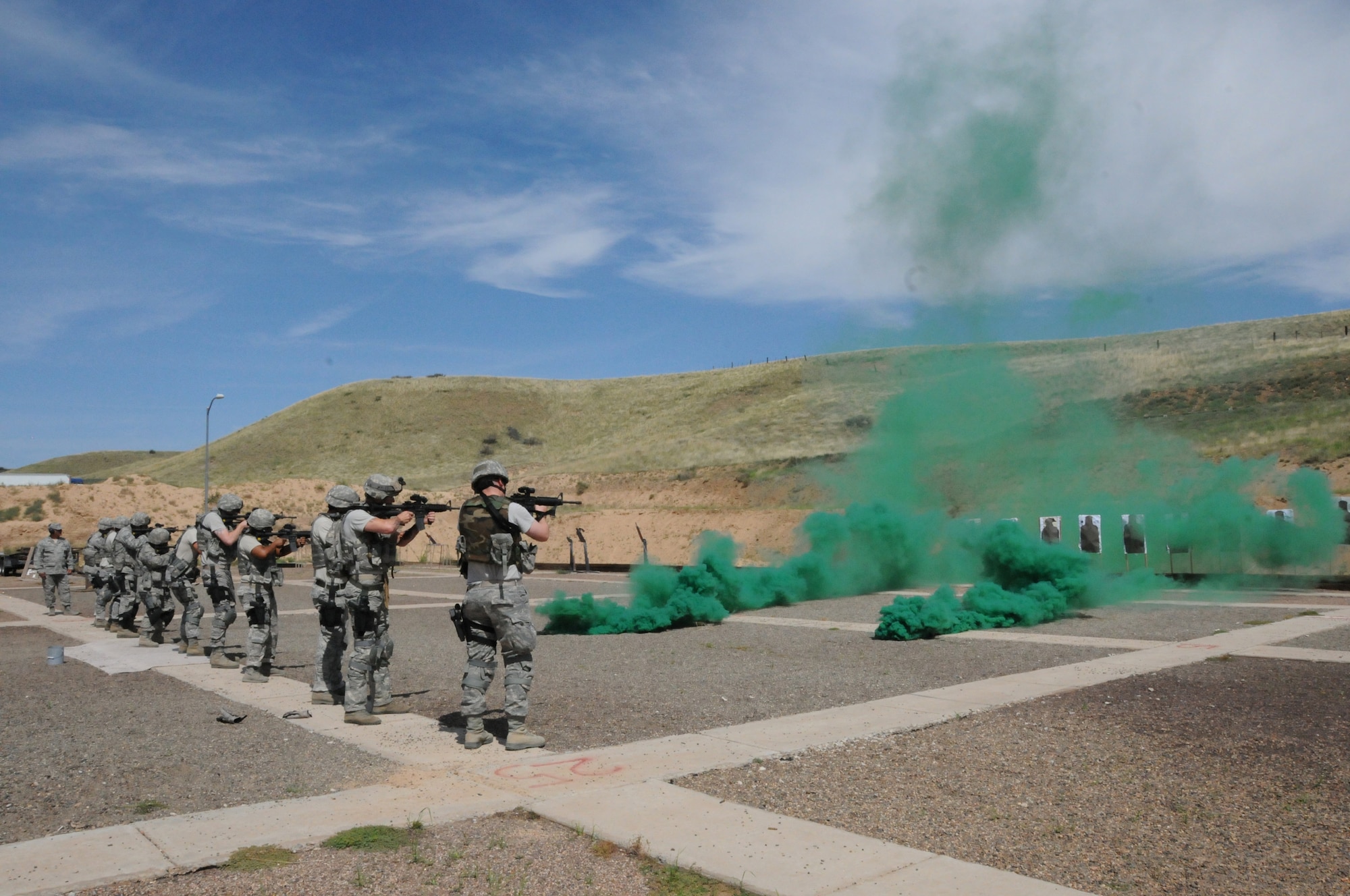 U.S. Airmen with the 161st Security Forces Squadron, Arizona Air National Guard, practice various weapons firing drills and scenarios at the Prescott Valley SWAT training grounds, Prescott Valley, Ariz., Aug. 3, 2013. The Airmen are preparing for an upcoming deployment with training focused on weapons firing, building entry and self-aid buddy care. (U.S. Air National Guard photo by Tech. Sgt. Susan Gladstein/Released)