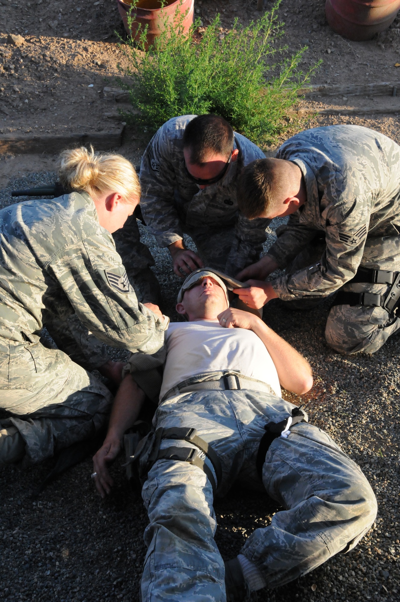 U.S. Airmen with the 161st Security Forces Squadron, Arizona Air National Guard, practice hands on self-aid and buddy care techniques at the Prescott Valley SWAT training grounds, Prescott Valley, Ariz., Aug. 3, 2013. The Airmen are preparing for an upcoming deployment with training focused on weapons firing, building entry and self-aid buddy care. (U.S. Air National Guard photo by Tech. Sgt. Susan Gladstein/Released)